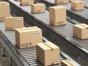Cardboard boxes on conveyor roller in distribution warehouse, Delivery and packaging service concept.